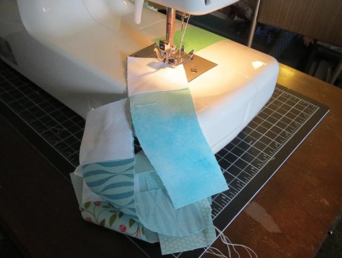 Sewing squares to strips.